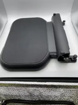 Robooter X40 footrest in black with textured surface and adjustable mounting bracket.