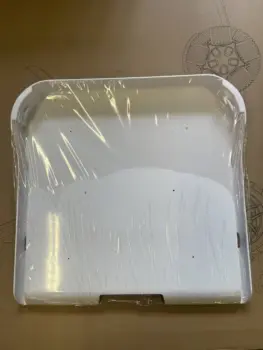 Robooter X40 seat shell in white plastic, shown with protective film wrapping.